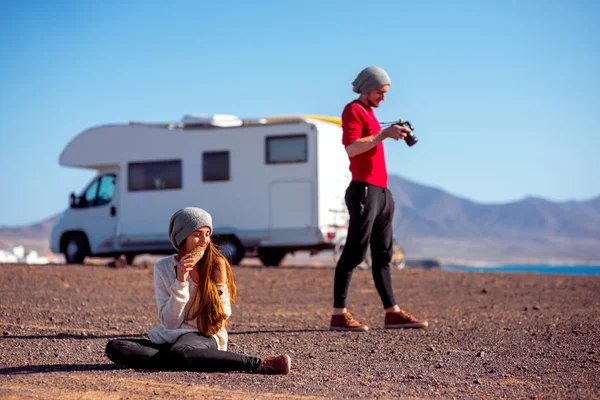 Couple traveling by camping trailer — Stok fotoğraf