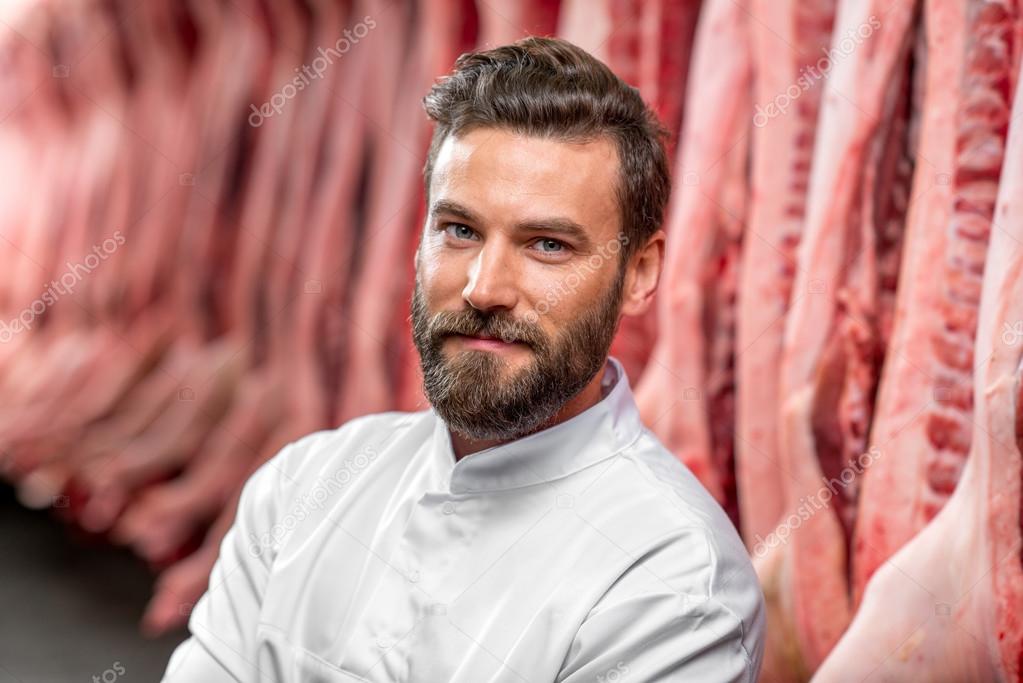 Portrait of a handsome butcher at the manufacturing