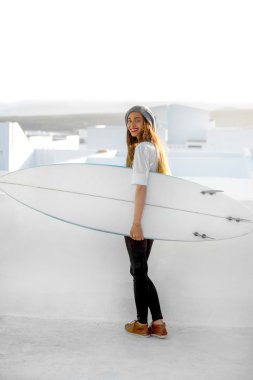 Kadın beyaz şehir arka plan üzerinde surfboard ile