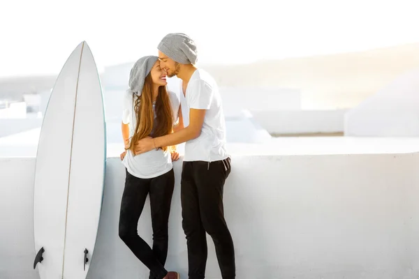 Pasangan dengan papan selancar di luar ruangan dengan latar belakang putih — Stok Foto