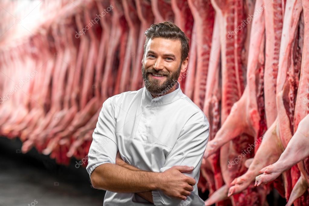 Portrait of a handsome butcher at the manufacturing — Stock Photo ...