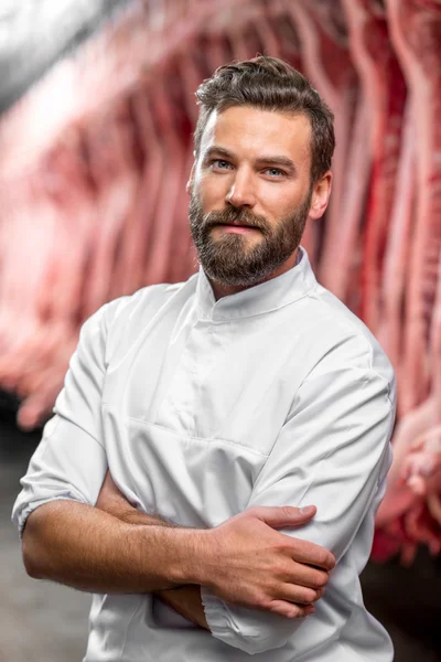 Portrait of a handsome butcher at the manufacturing — Stock Photo, Image