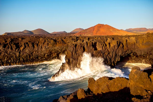 Rocky coast with wavy ocean on Lanzarote island Stock Picture