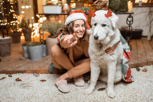 La mujer que celebra con el perro las fiestas de Año Nuevo en casa — Foto de Stock