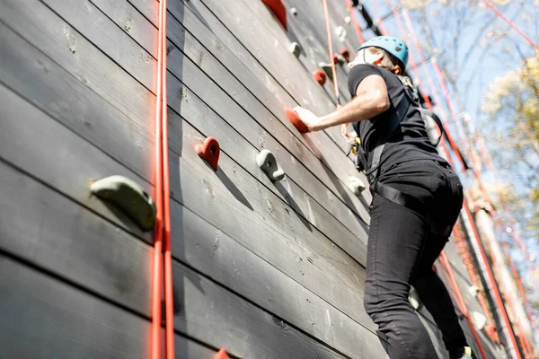 Man climbing the wall in the park