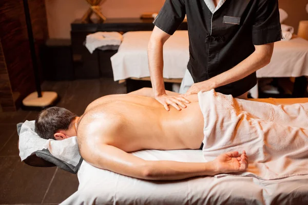 Man receiving a deep massage — Stock Photo, Image