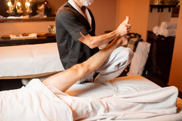 Masseur doing a deep massage to a male client — Stock Photo, Image