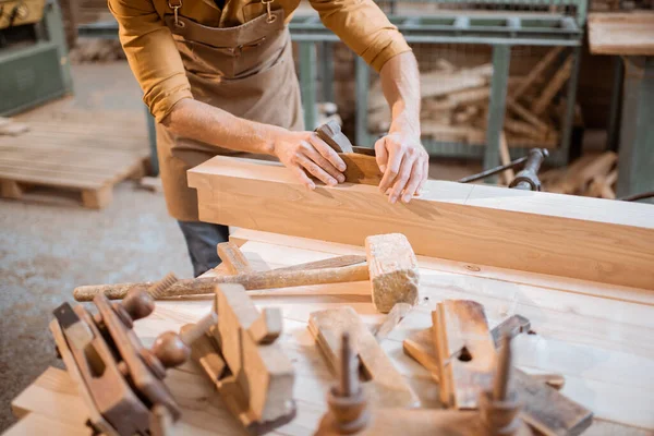 Carpenter working with a wood in the workshop — Stock Photo, Image