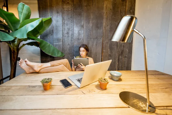 Mulher criativa com um tablet digital em casa — Fotografia de Stock