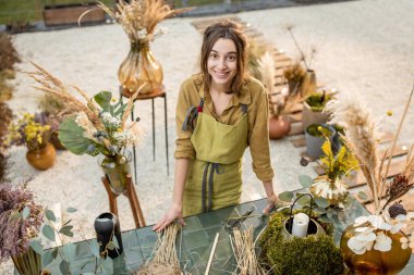 Çiçek kompozisyonları yapan bir kadın