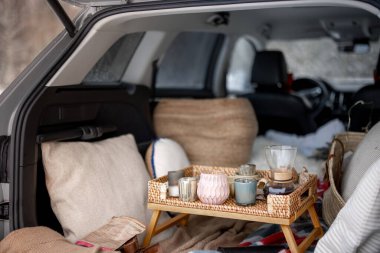 A cozy picnic in car trunk during winter clipart