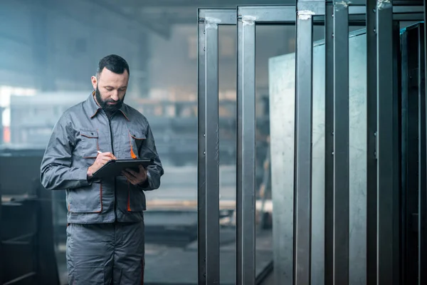 Worker with a digital tablet at the plant — Stock Photo, Image