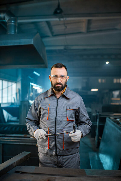 Metal industry worker at factory in work wear 