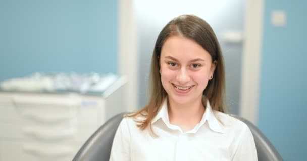 Portrét veselého děvčete v zubních rovnátkách na zubní ordinaci — Stock video