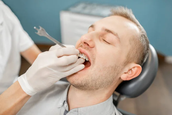 Стоматолог и пациент во время ортодонтического лечения — стоковое фото
