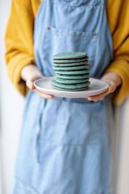 Kadınların elinde bir yığın mavi krep. 