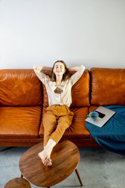 Evdeki kanepede dinlenen kadın. 