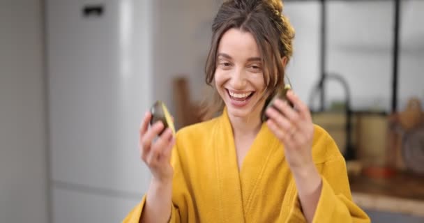 Happy woman with avocado in the morning at home — Stock Video