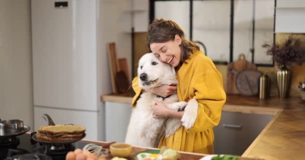 Woman with dog on the kitchen in the morning Stock Video