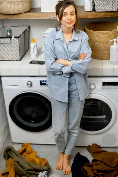 Portrait of a happy young housewife with clean clothes — Stock Photo, Image