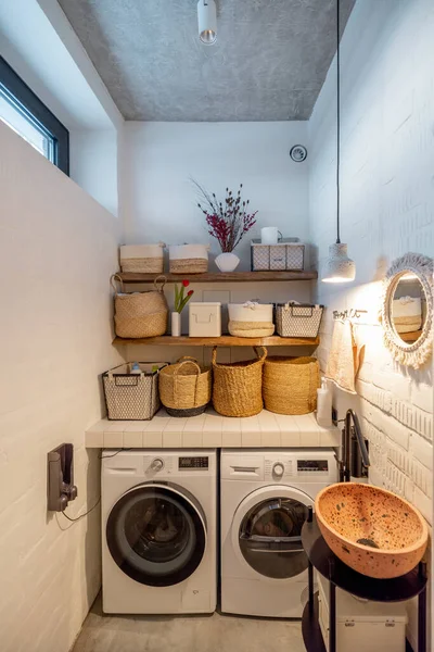 Home laundry with machines and clothes baskets