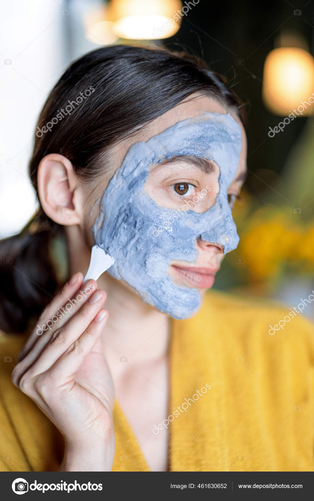Woman applying bubble cleansing mask Stock Photo by ©rossandhelen 461630652