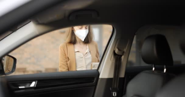 戴口罩的女人坐在装有外卖食品的车上 — 图库视频影像