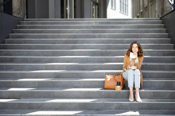 Mujer tienen almuerzo al aire libre en las escaleras cerca del edificio de oficinas —  Fotos de Stock