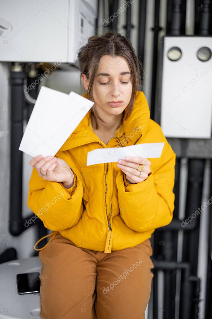 Woman checking bills for electricity at home
