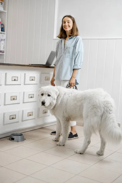 Vrouw met grote witte hond in veterinaire kliniek — Stockfoto