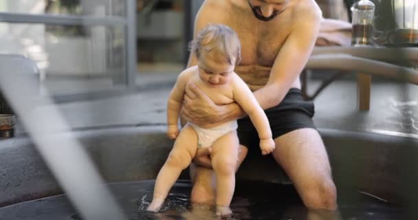 Father bathing with his little baby son at spa outdoors — Wideo stockowe