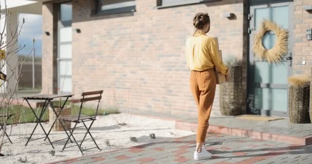 Vrouw brengt pakjes naar huis — Stockvideo