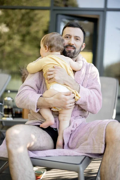 Otec s jednoletým chlapečkem odpočívajícím v lázeňském středisku — Stock fotografie