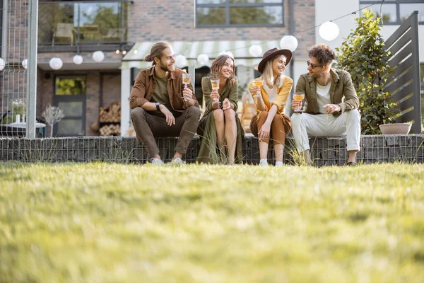 Friends gathering together on a porch of a country house — Stock Photo, Image