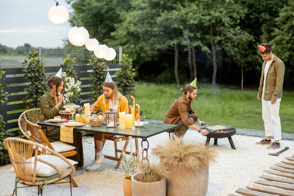 Friends having great festive summertime on a backyard