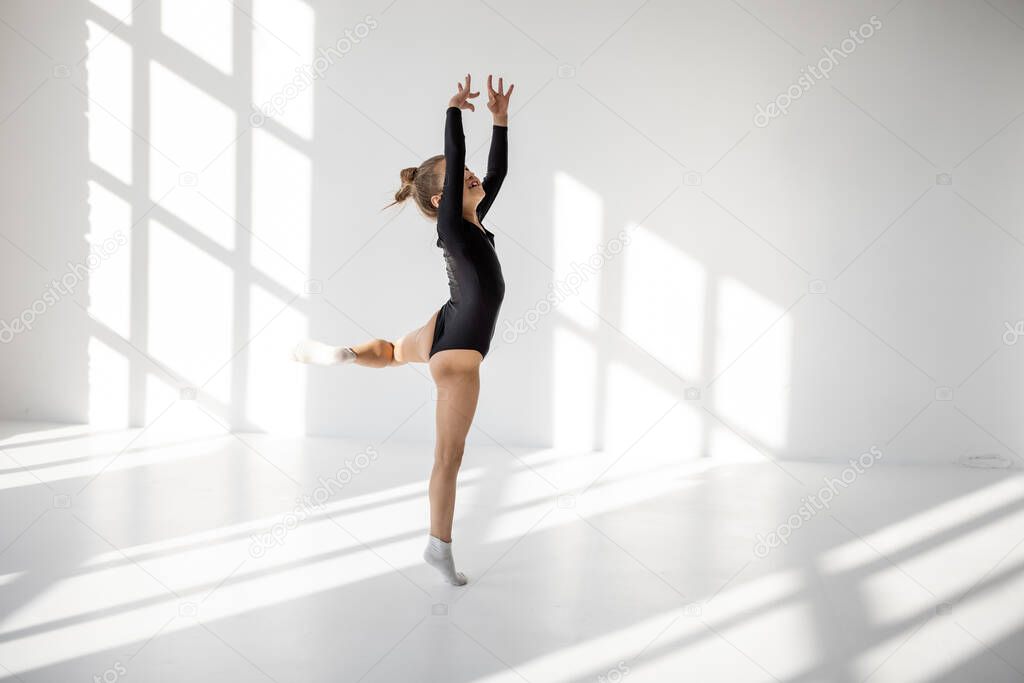 Little girl practising rhythmic gymnastics