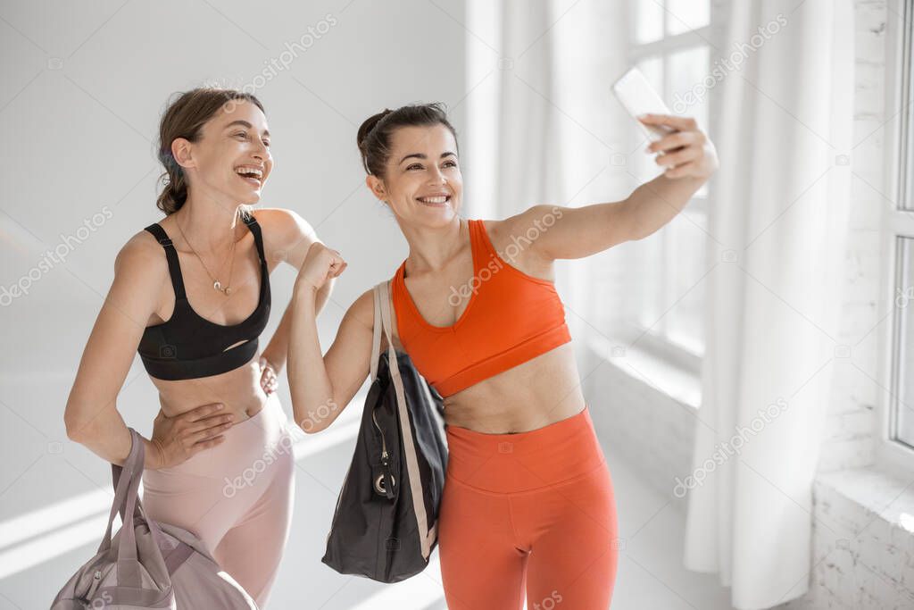 Sports women making selfie at gym