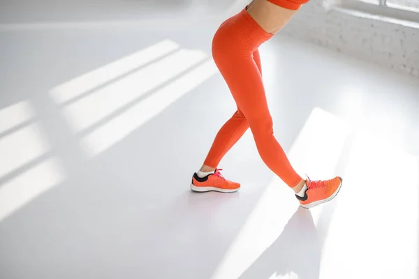 Jaki sport lubisz najbardziej? woman stretching indoors, close-up on legs — Zdjęcie stockowe