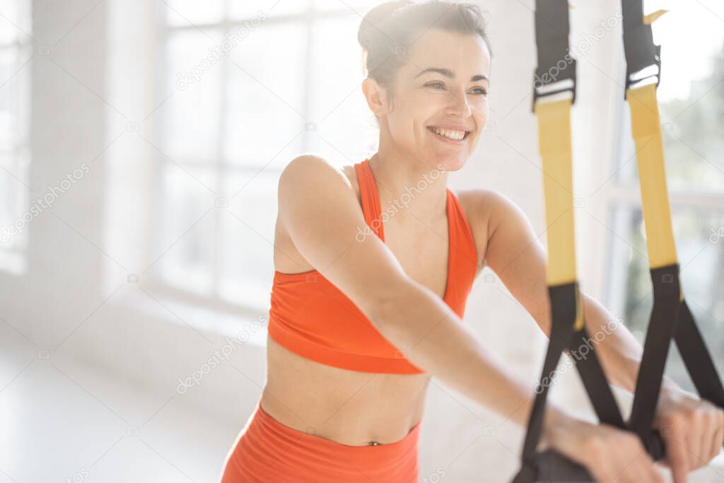 Woman training on TRX fitness straps