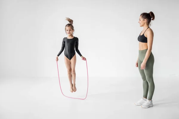 Woman with a little girl on rhythmic gymnastics training