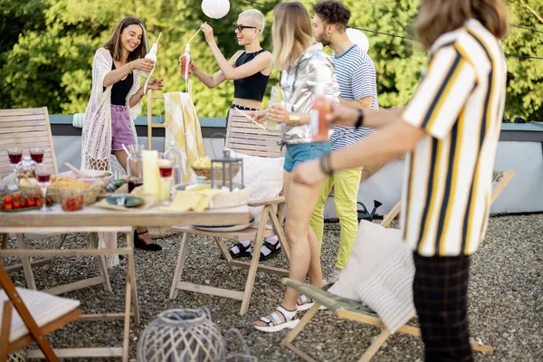 Jeunes amis élégants ayant un dîner festif sur la terrasse du toit — Photo