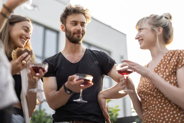 Vrienden feesten buiten met alcoholische dranken — Stockfoto
