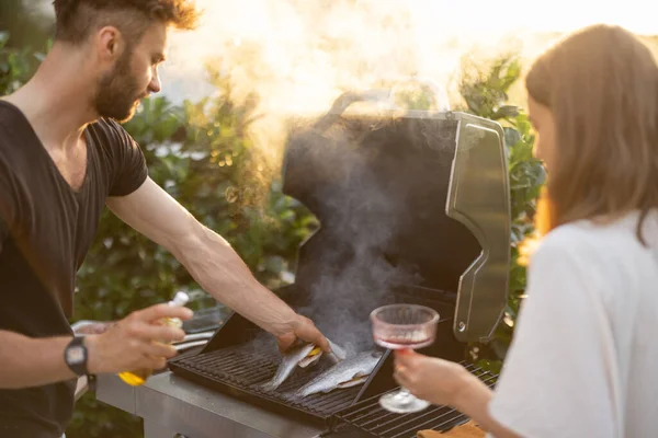 Man cooking fish on a grill — Stock Photo, Image