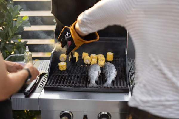 Grilling fish and corn on a grill — Stock Photo, Image