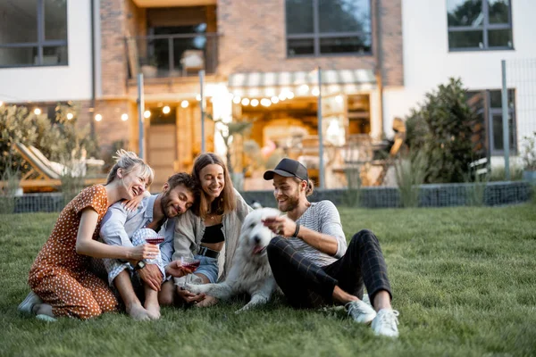 Vänner som har kul på bakgården på kvällen — Stockfoto