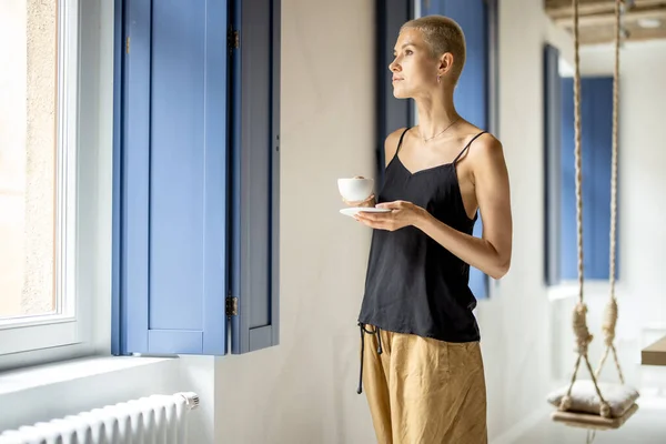 Woman enjoys coffee at home