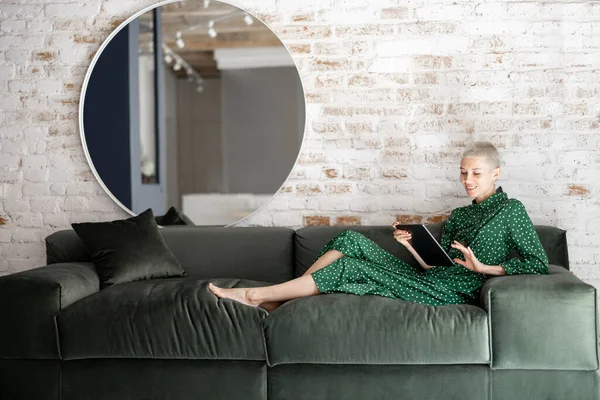 Mujer con estilo con tableta digital en el sofá en casa — Foto de Stock