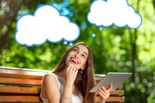 Young woman with digital tablet in the park — Stock Photo, Image