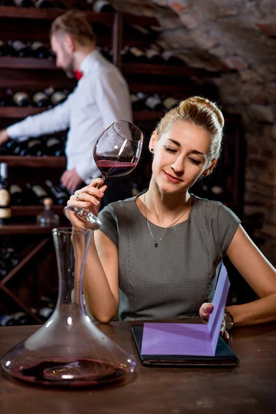 Woman tasting wine in the cellar Royalty Free Stock Images