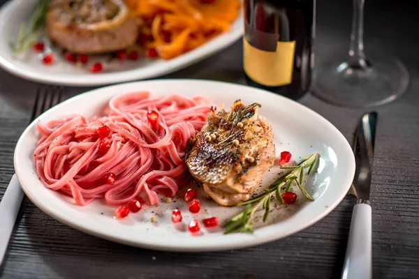 Pasta with steak on wooden table — Stock Photo, Image